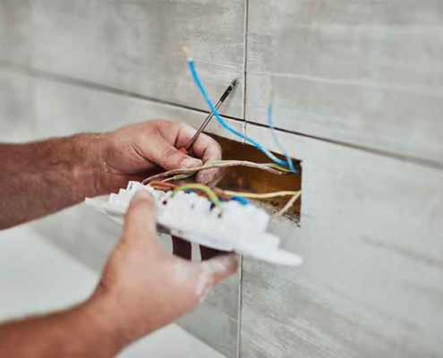 Electrician reparing and wall socket
